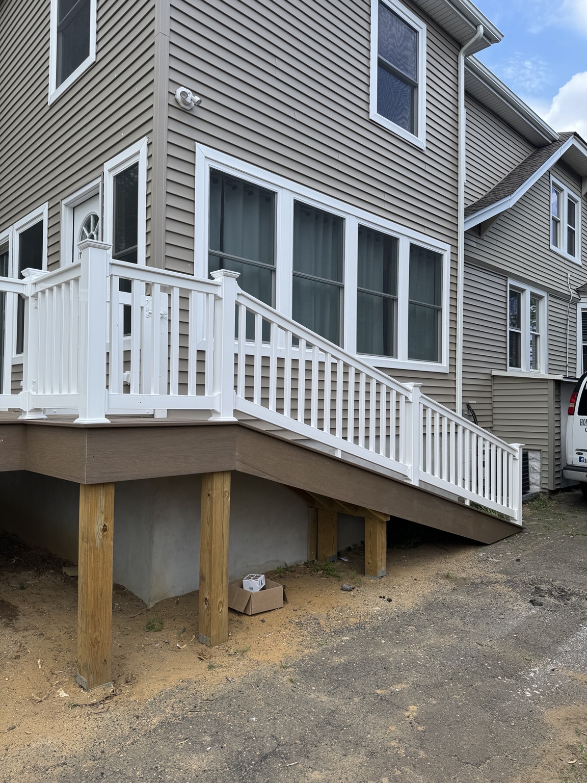 Closer view of white vinyl railing and stair detail by Zuniga Carpentry LLC